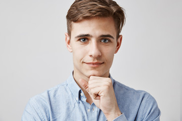 Close up portrait of attractive young guy. Please, talk, I am listening. Handsome young man hears...