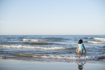 Fototapeta na wymiar little girl vacationing on the beach