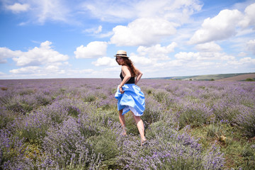 A woman in a straw hat in a lavender field