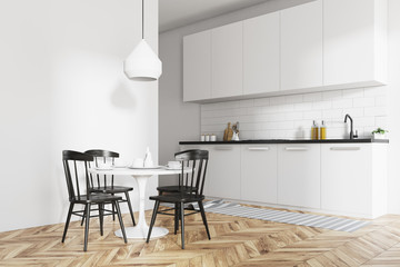 Interior of a white dining room and kitchen