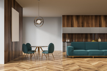 Wooden dining room, green sofa, poster