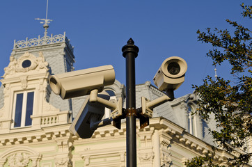 Fototapeta na wymiar Security CCTV camera on street lamp in the city center
