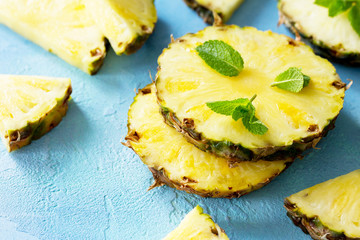 Fresh slice pineapple on stone background or slate with copy space. Food concept. Copy space.