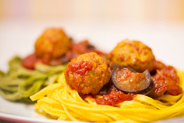 Pasta with meatballs, tomatoes and eggplant
