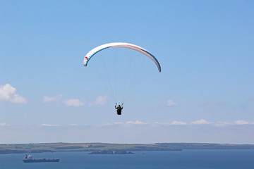 Paraglider flying above Newgale Bay