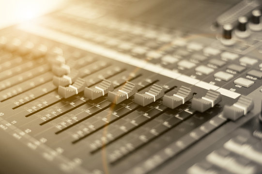 digital audio sound mixer panel with a sunlight in warm toning