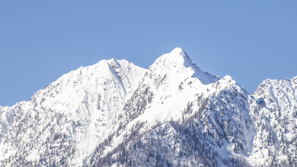 European alps full of snow in a blue sky