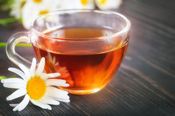 Chamomile tea in a transparent cup. The concept of herbal medicine.