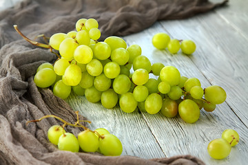 bunch green grapes on a grey wooden background