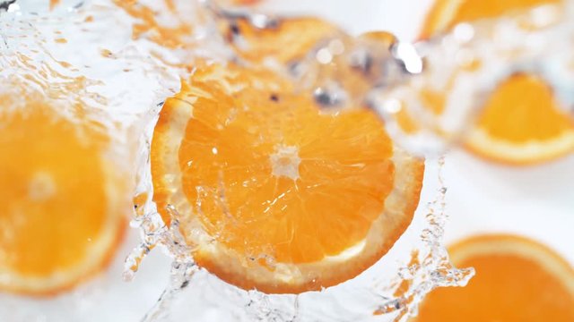 Water splash on sliced orange. Shot with high speed camera, phantom flex 4K. Slow Motion.