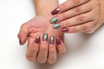 beige manicure dior with sequins on long square nails on a white background on tanned hands
