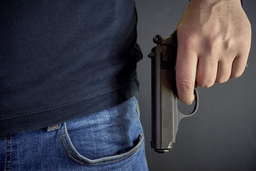 Killer holding a gun side him, robbery, murder, crime