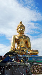 Fototapeta premium golden buddha statue in front of sky, Thailand