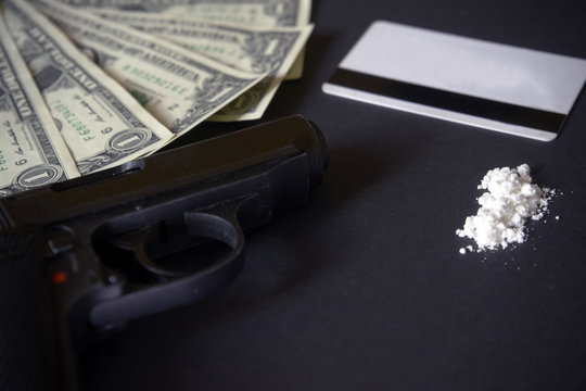 Credit card, gun, road of cocacine. drug powder