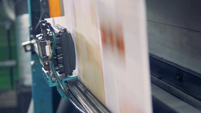 Whole printed web of paper is moving down the industrial machine