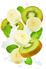 Flying kiwi and banana with mint leaves and a spray of milk