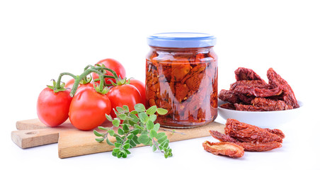 Dried tomatoes in olive oil on white background