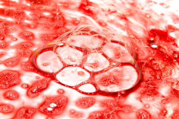 A red abstract paint on white background