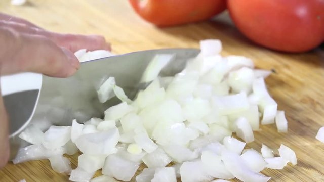 Closeup of chopping onions on a cutting board
