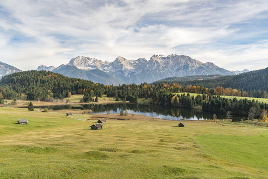Lodges with Gerold lake and Karwendel Alps in the background. Kr&uuml;n, Upper Bavaria, Bavaria, Germany.