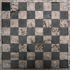 Background: weathered stone chessboard