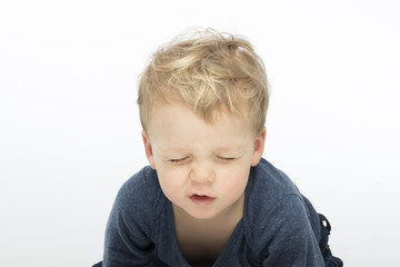 screwed-up toddler on white background. Studio shot