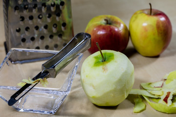 The apple grated on a kitchen grater. Kitchen countertop and preparation of salads.