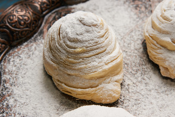 Badambura powdered pastry on Novruz tray. Azerbaijan traditional pastry cookie badambura on rustic table background