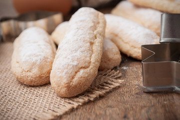 closeup of traditional homemade biscuit with icing sugar on wooden table background