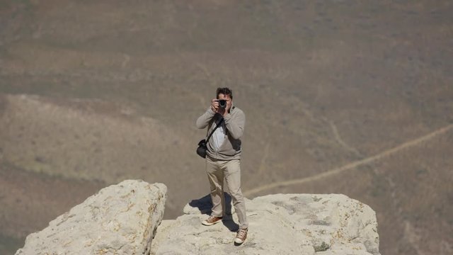 Man taking pictures from a rock