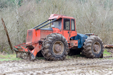 A skidder with chains
