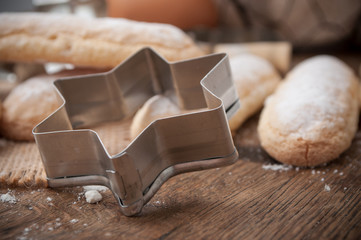 closeup of traditional homemade biscuit with icing sugar on wooden table background