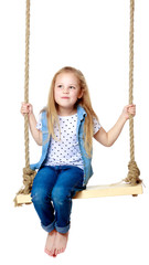 Little girl swinging on a swing