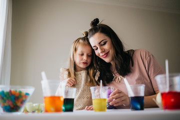 Mother and Daughter Painting Easter Eggs together