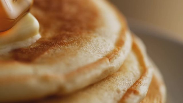 Pouring honey on stack of pancakes. Shot with high speed camera, phantom flex 4K. Slow Motion.