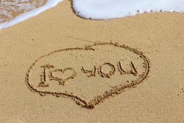 The writing on sand, I love you. Oceanic foam.