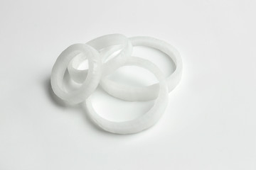 Rings of fresh onion on white background