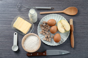 Set of kitchen utensils with products on wooden background. Cooking master classes
