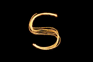 Light painting alphabet S on black back ground isolate.