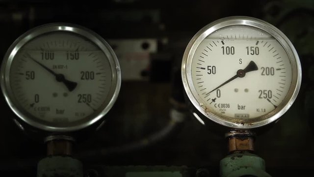Two Similar Pressure Gauges on Heavy Equipment. Close-Up.