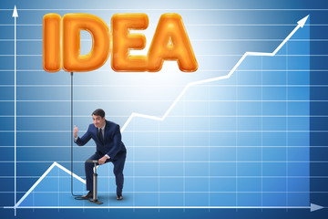 Businessman pumping innovative idea balloon