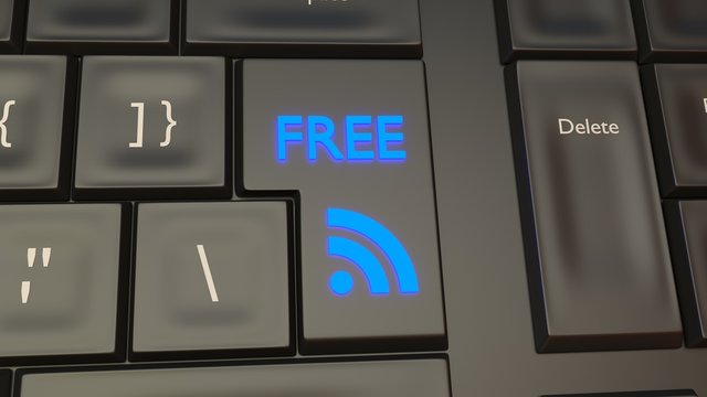 Free WIFI internet connection button on a black keyboard and a blue signal