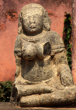 Closeup of ruins of ancient Hindu goddess stone carving in a temple