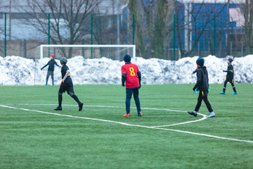 two football teams play on the winter stadium