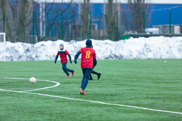 two football teams play on the winter stadium
