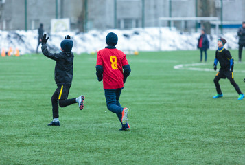 Fototapeta premium two football teams play on the winter stadium