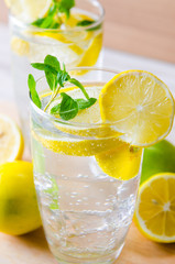 Glasss of mojito with lemon and drinking straw