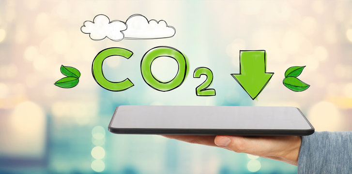 Reduce CO2 with man holding a tablet computer