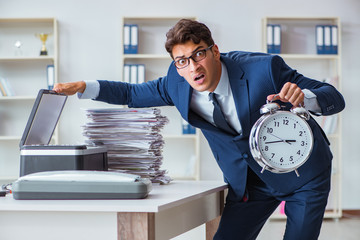 Businessman making copies in copying machine