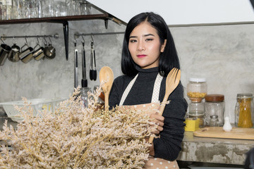 Asian female chef is cooking